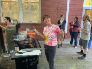 Anne Frances Jarrell cooks burgers for her classmates at a cookout on the back deck of CAGT (Athens campus).